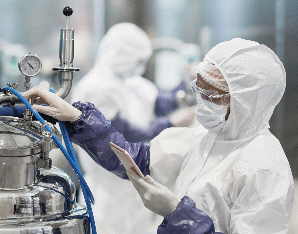 vertical-portrait-female-worker-wearing-protective-suit-while-operating-equipment-modern-chemical-plant-copy-space